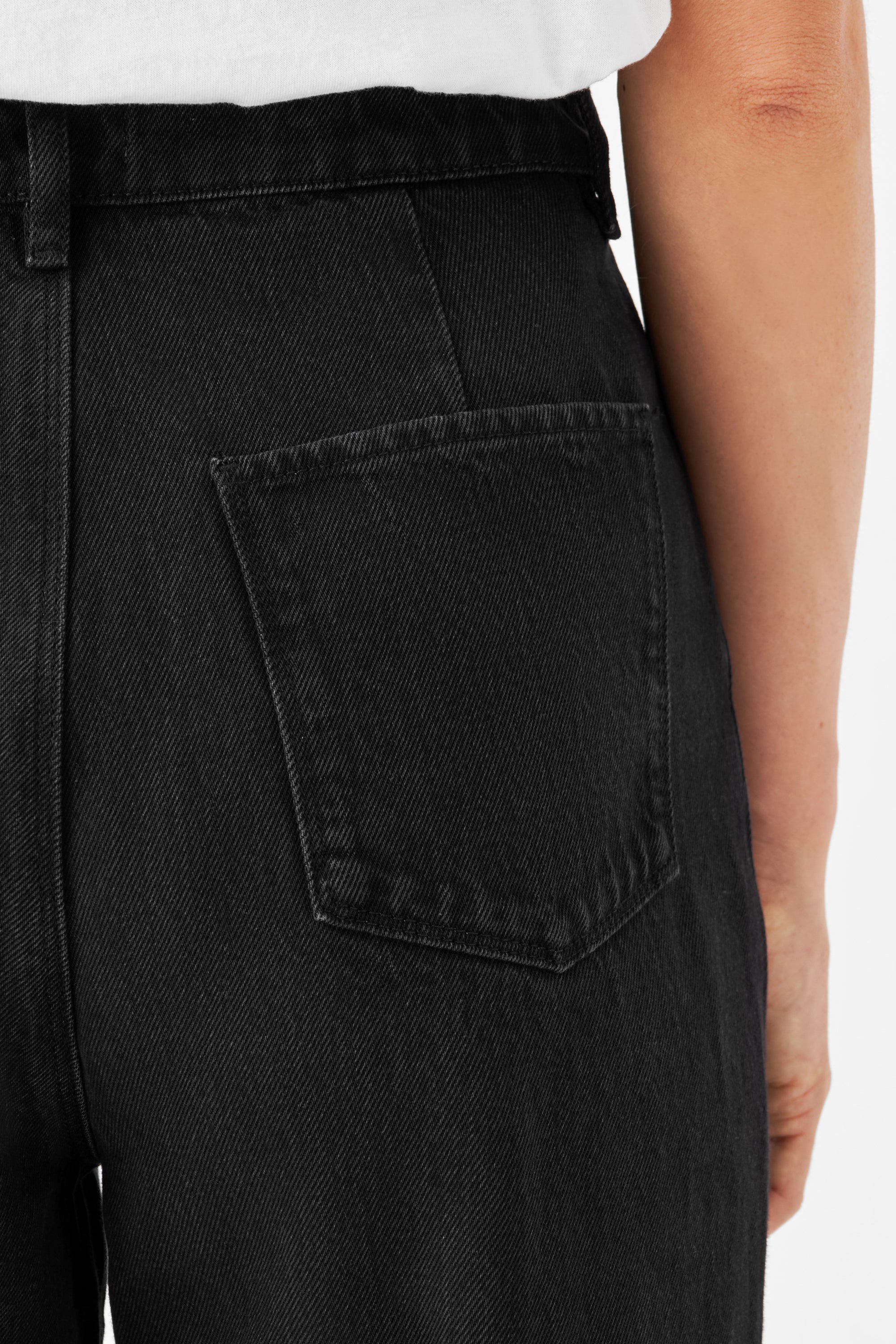 Schwarze DAWN Denim-Jeans mit hoher Taille; Nahaufnahme der Rückentasche aus 100% Bio-Baumwolle.
