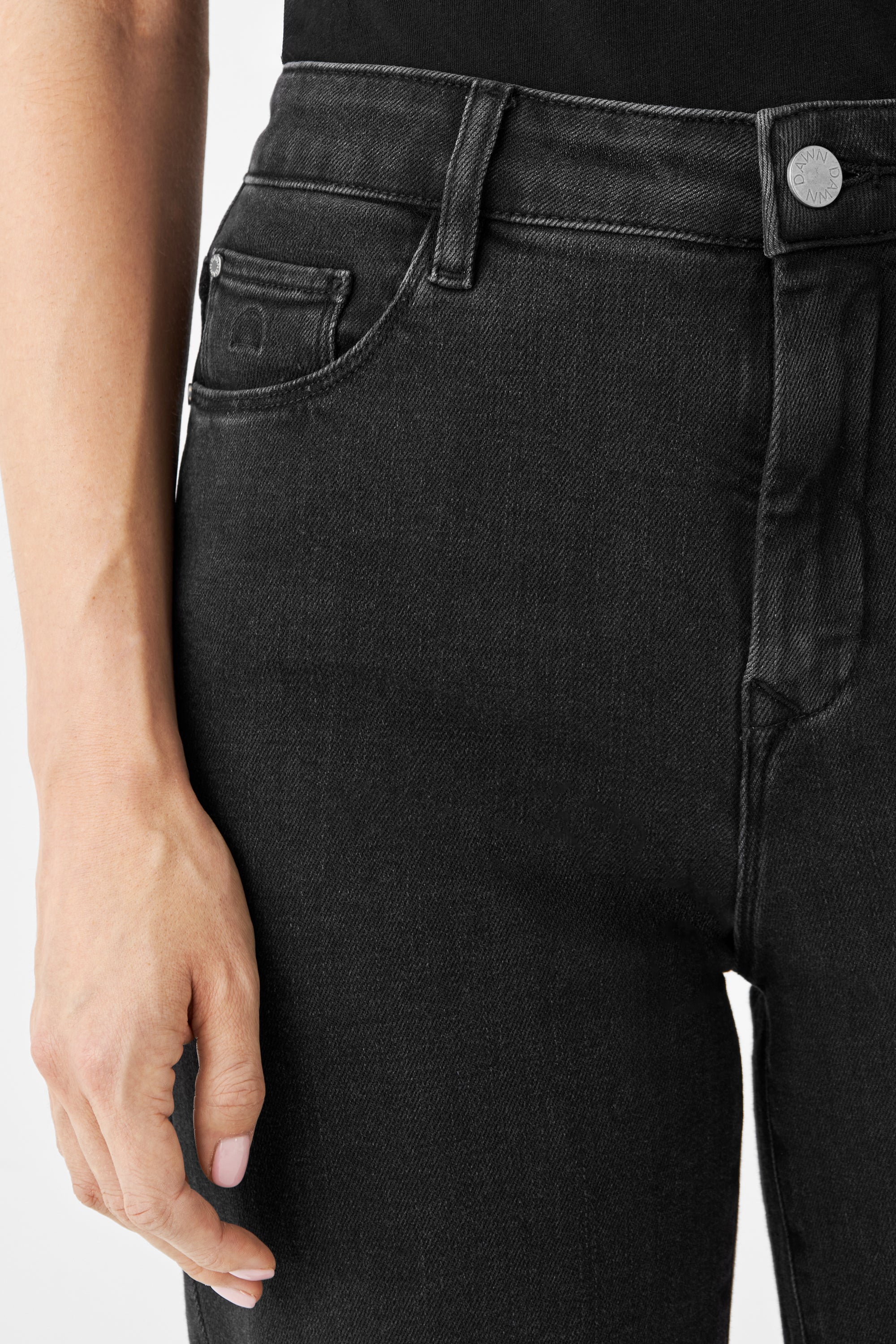 Schwarze DEW Classic High-Waist-Denim-Jeans, Vorderansicht mit Münztasche, Fronttaschen und Gürtel-Schlaufen; silberner Knopf mit DAWN-Logo.