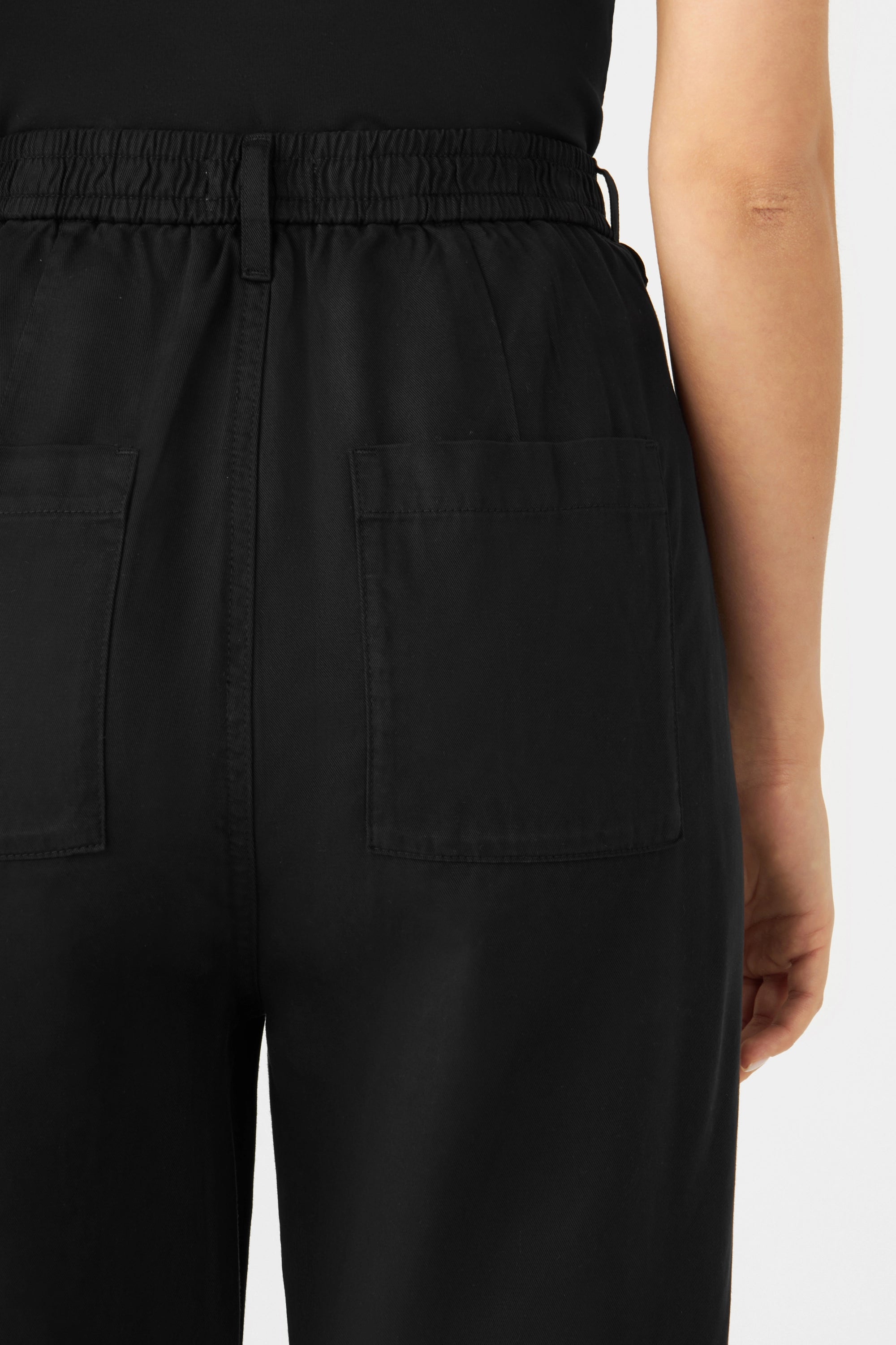 Schwarze SUNSHINE Tencel Classic Jogger, Rückansicht: elastischer Bund hinten und zwei aufgesetzte Gesäßtaschen, mittlere Taille, lockere Passform.